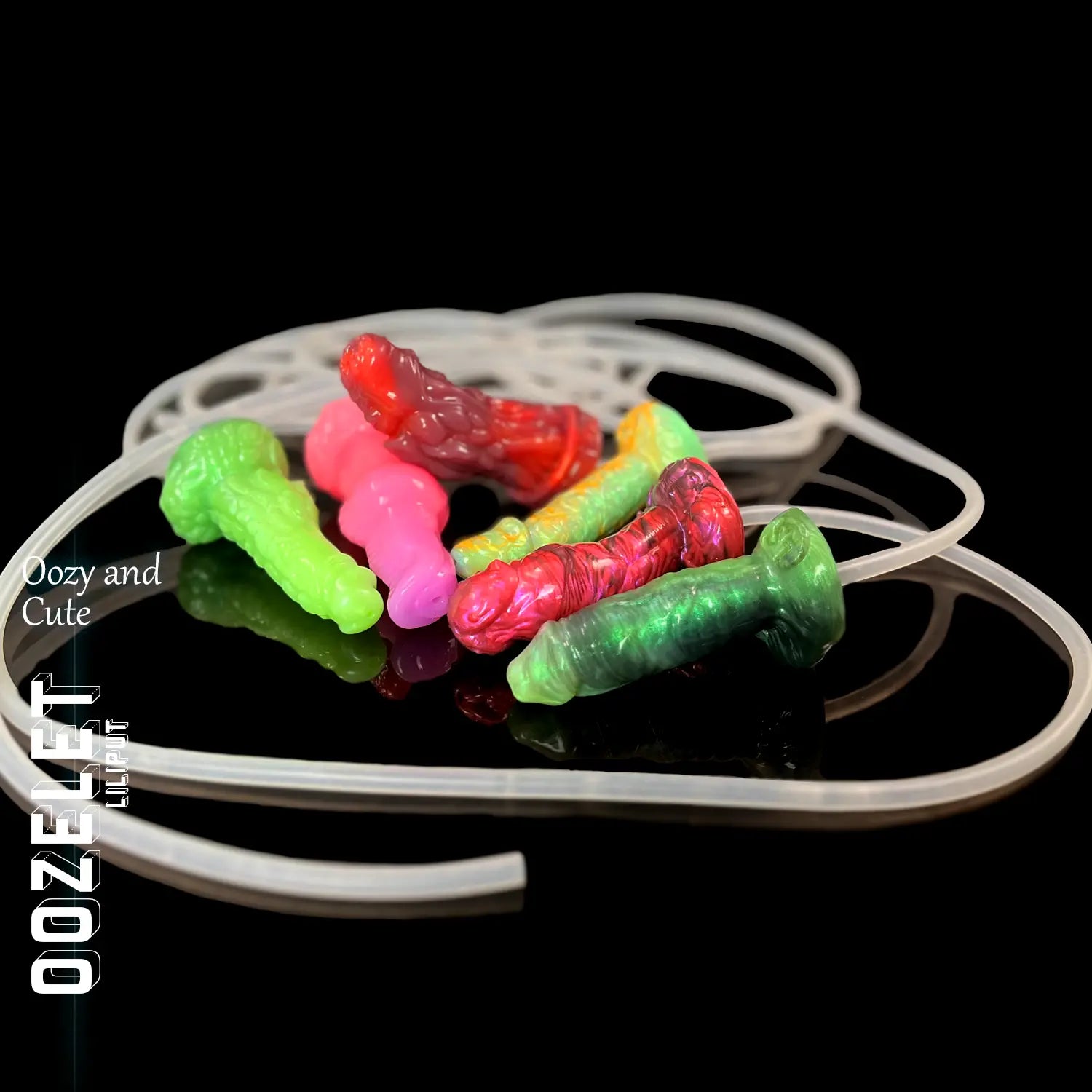 Oozelet Liliput collection of small fantasy-inspired toys in vibrant colours, with syringe and tubing set – compact, playful