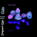 Cute size Dragoness Egg fantasy butt plug in purple and blue marble silicone glowing under black light, handmade textured dragon scale anal toy.