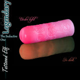 Legendary Tattooed Elf fantasy silicone masturbator in phosphorescent pink, shown under normal light and glowing in the dark